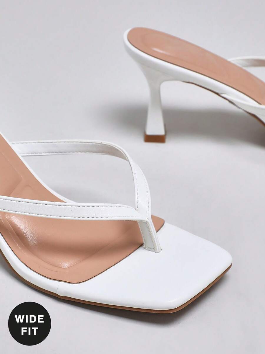Women's square toe kitten heel thong heeled sandals featuring an asymmetrical strap design and mid heel