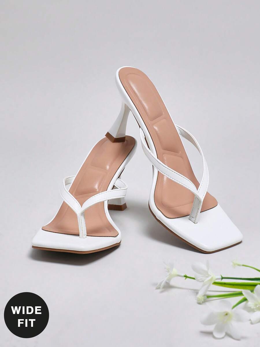 Women's square toe kitten heel thong heeled sandals featuring an asymmetrical strap design and mid heel