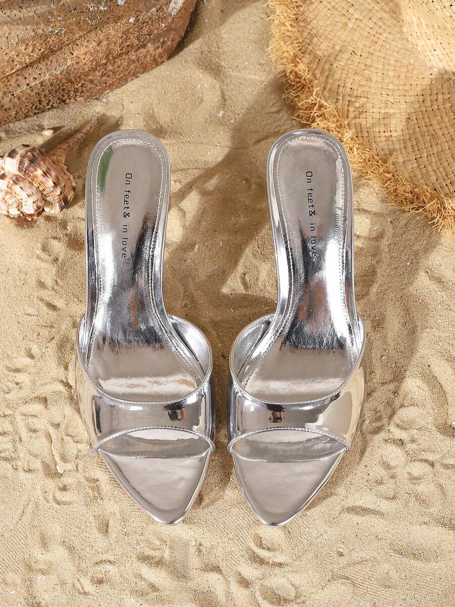Women's open toe slide sandals featuring sleek patent leather and thin stiletto heels