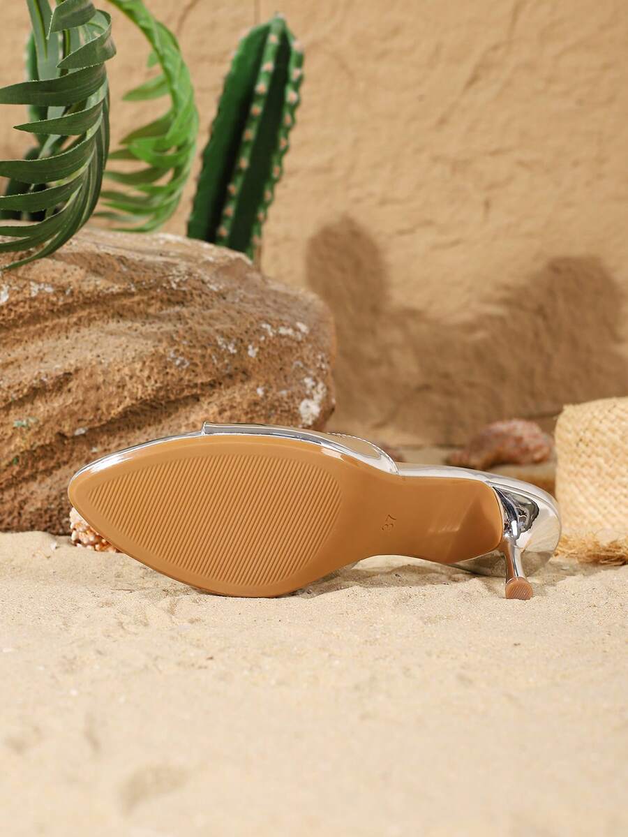 Women's open toe slide sandals featuring sleek patent leather and thin stiletto heels