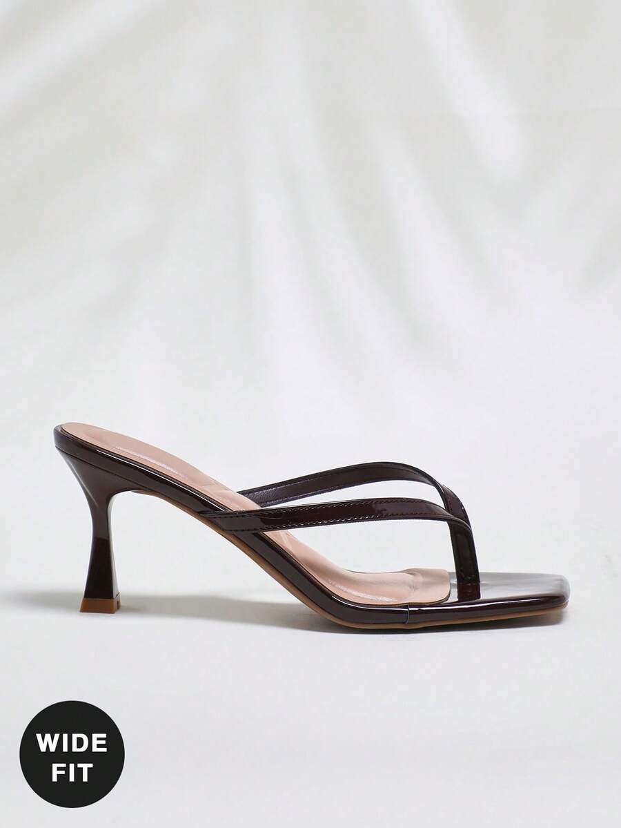 Women's square toe kitten heel thong heeled sandals featuring an asymmetrical strap design and mid heel