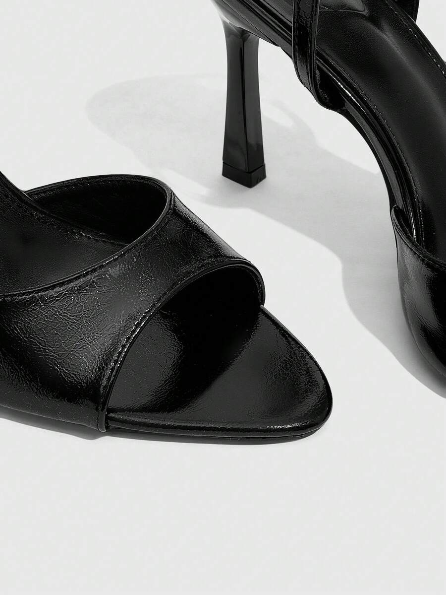 Pair of women's black high heel sandals with open toe design, slim stiletto heel, and adjustable ankle buckle strap.