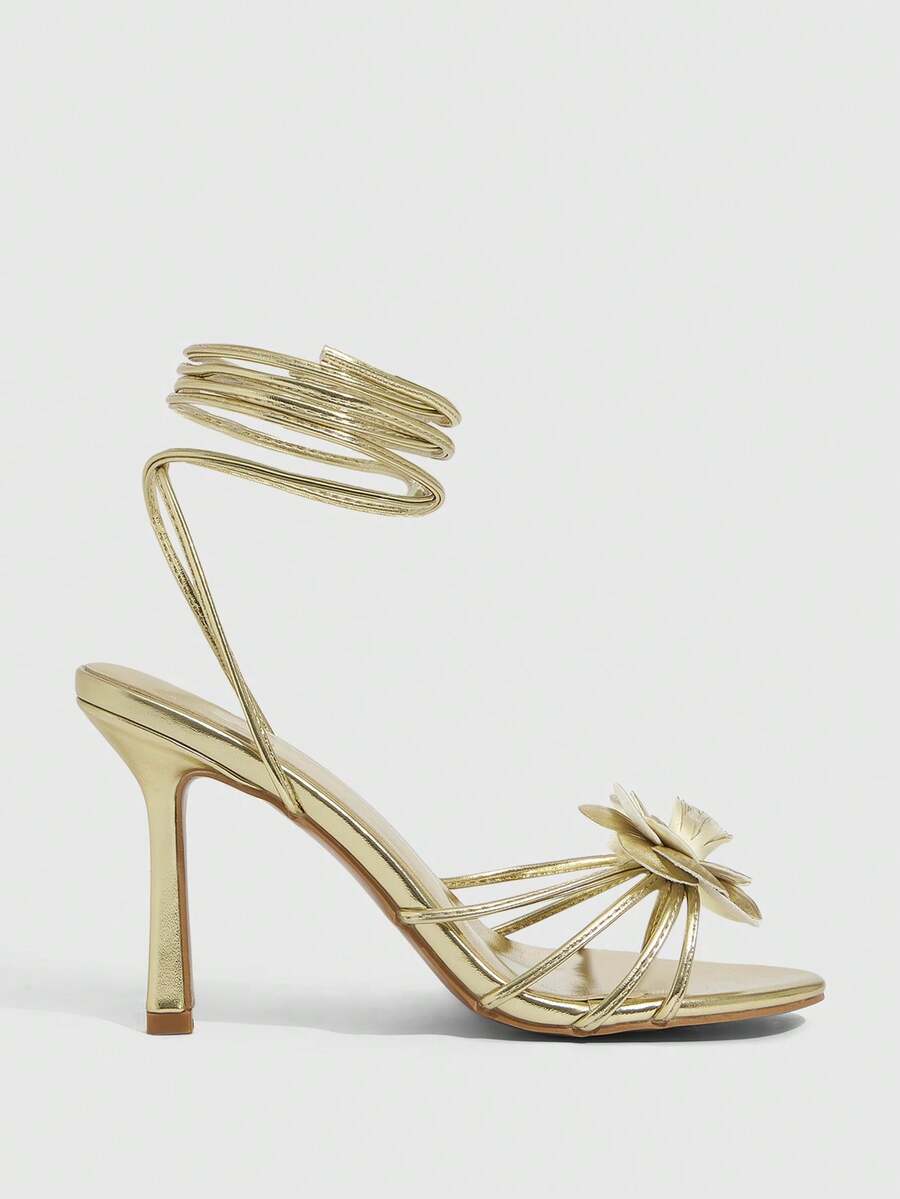 Women's round toe high heel sandals with brown flannel finish, floral trim detail, and strappy lace-up stiletto design.