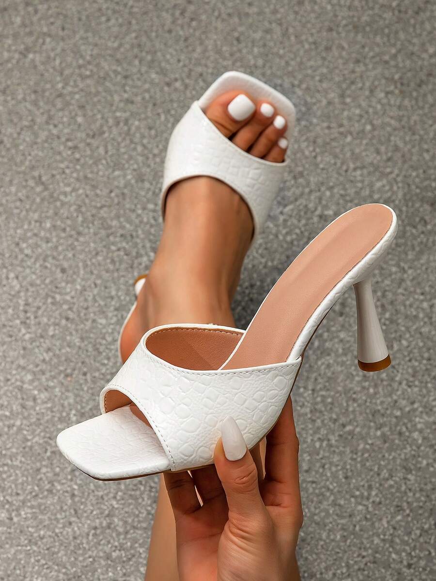 Women's high heel slip-on dress sandals featuring a textured strap and elegant thin pyramid heel