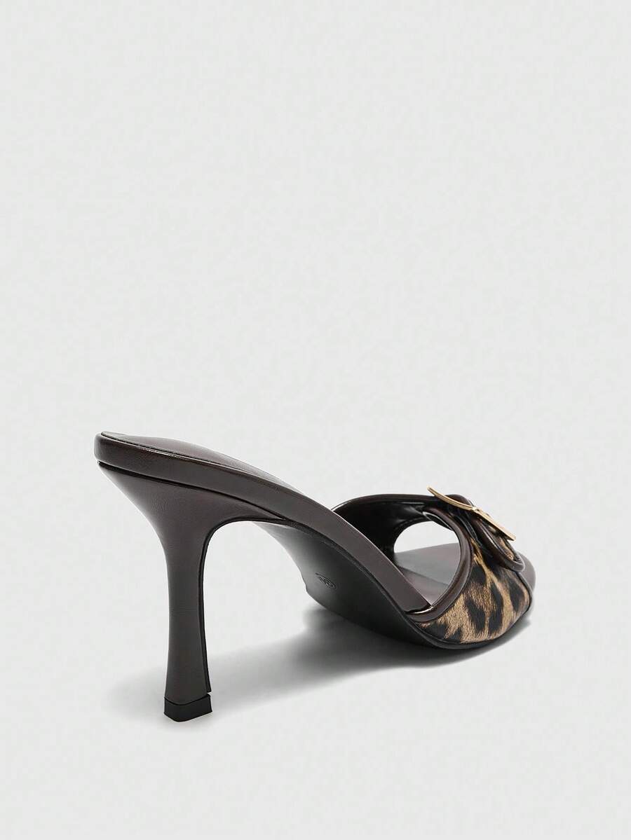 Women's brown leopard print high heel mule sandals with gold-tone buckle and grommet eyelet accents.
