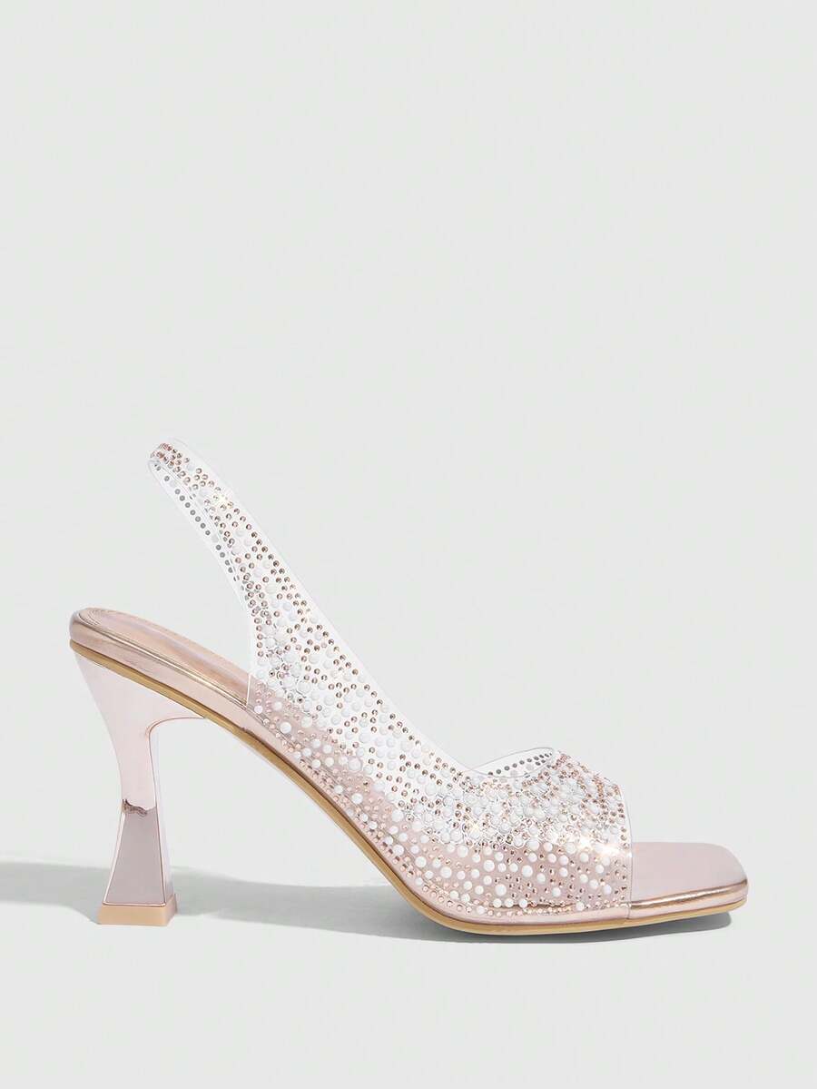 Women's square toe heeled sandals with clear straps, sparkling rhinestone embellishments, and a high pyramid heel.