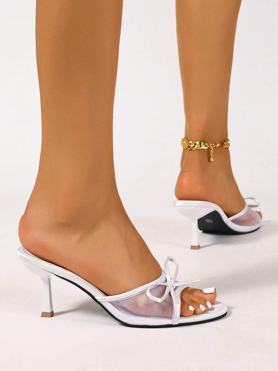 Women's black open toe mesh slide sandals with bowknot detail and stiletto heels