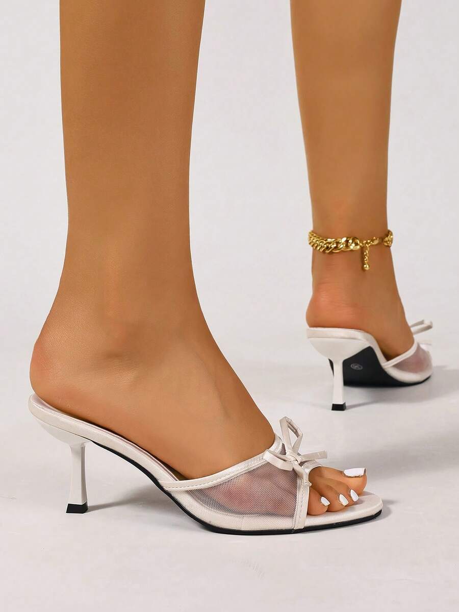 Women's black open toe mesh slide sandals with bowknot detail and stiletto heels