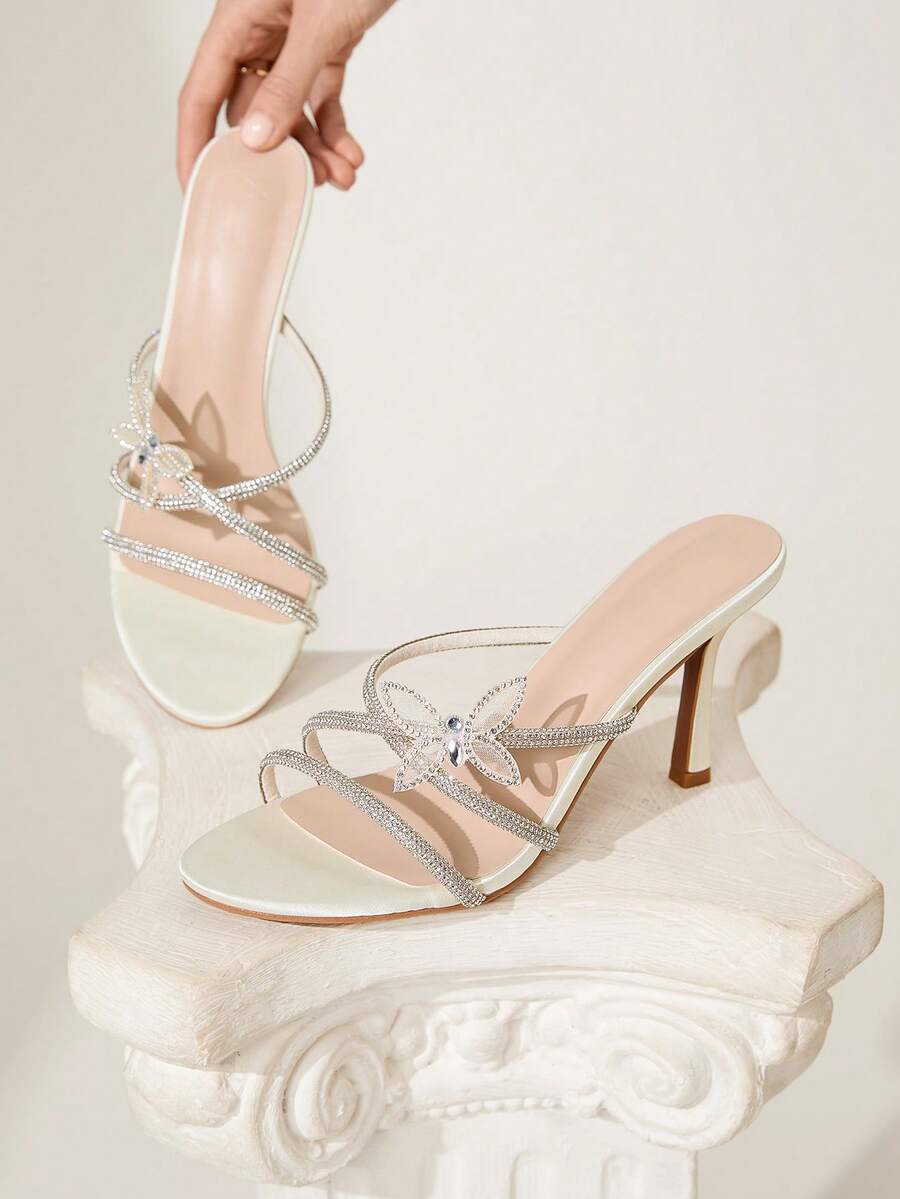 Butterfly high heel sandals featuring crystal embellished ankle straps, open toe design, and sleek stiletto heels for wedding and party wear.