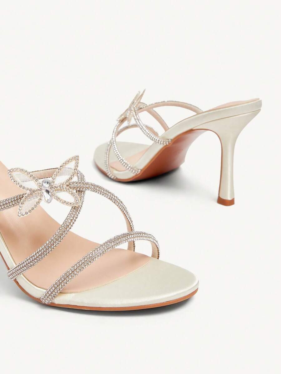 Butterfly high heel sandals featuring crystal embellished ankle straps, open toe design, and sleek stiletto heels for wedding and party wear.