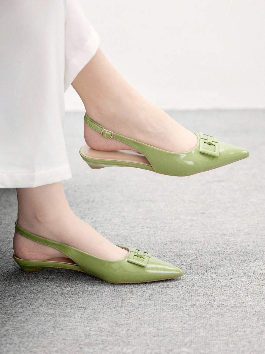 Women's pointed toe low wedge flat shoes crafted in PU leather with a slingback strap and stylish metal buckle detail.