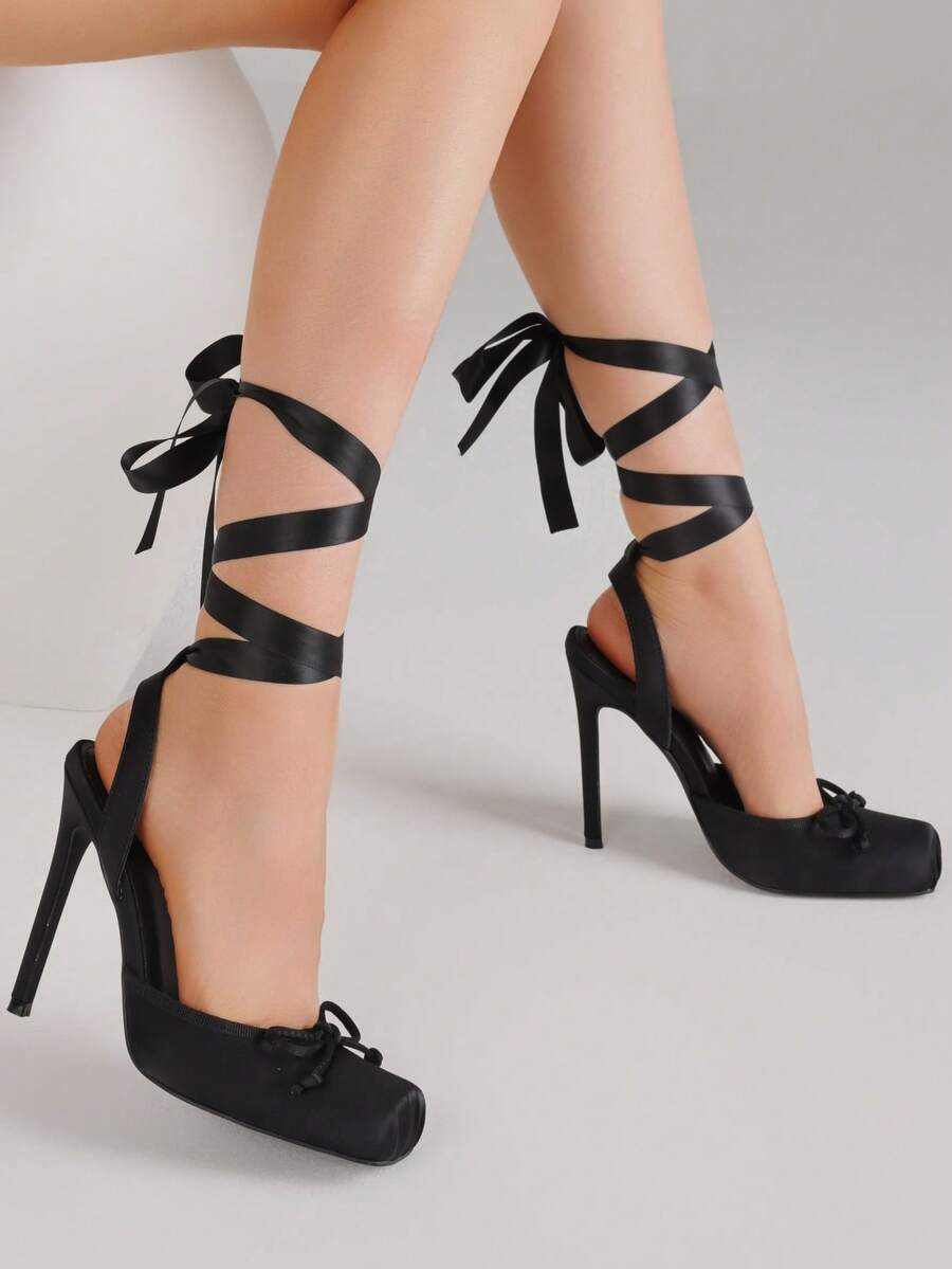 Women's square toe satin ballet stiletto heels with lace-up straps and bow detail.
