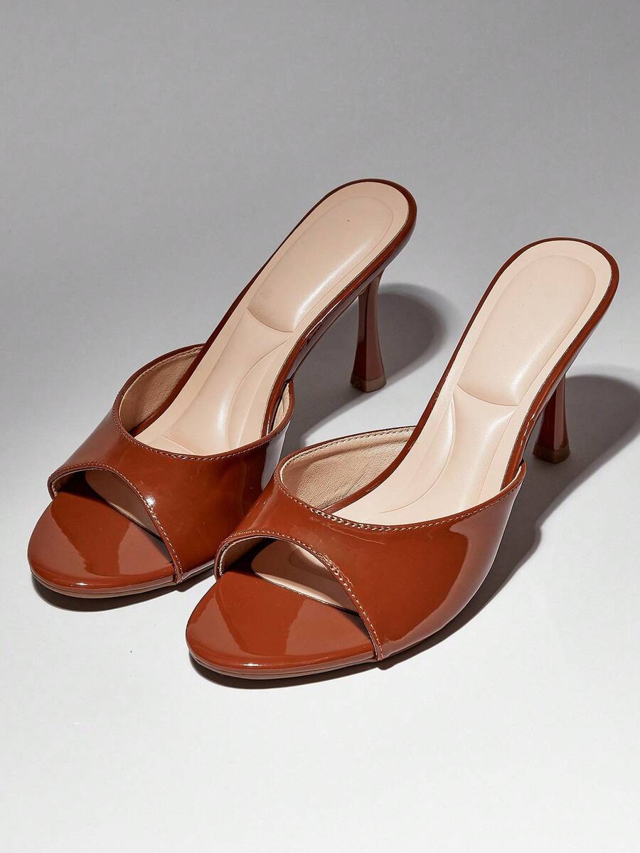 Women's pointed toe stiletto high heel wedding shoes featuring an elegant silhouette and glossy finish.