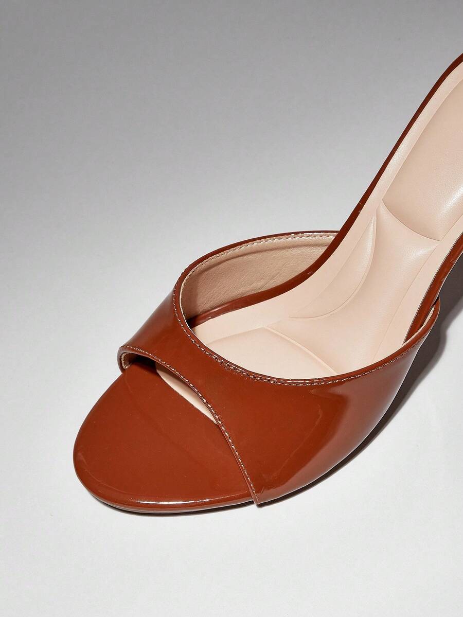 Women's pointed toe stiletto high heel wedding shoes featuring an elegant silhouette and glossy finish.