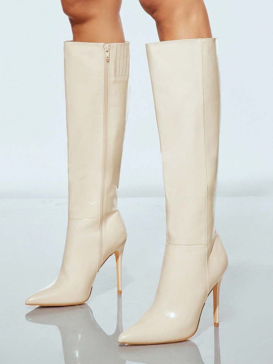Women's black pointy toe stiletto heel boots featuring a side zipper closure and sleek faux leather finish.