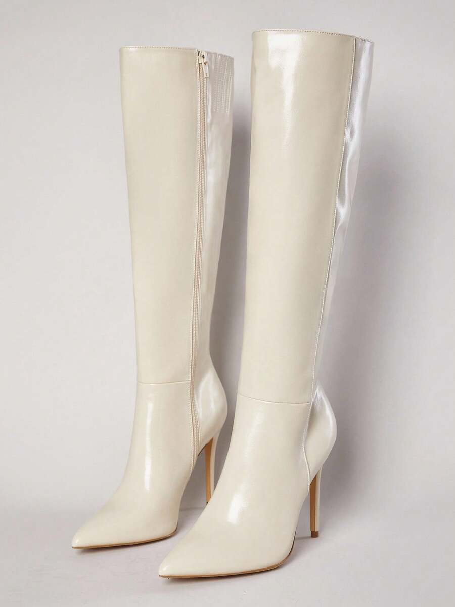 Women's black pointy toe stiletto heel boots featuring a side zipper closure and sleek faux leather finish.