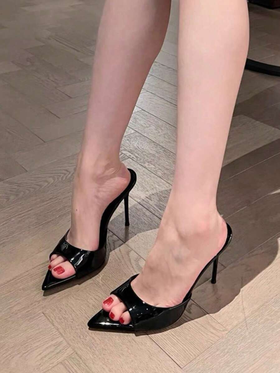 Patent leather open toe slingback slide sandals with stiletto high heels and slip on design.