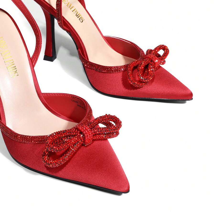 Women's rhinestone ankle strap high heels with pointed closed toe, strappy bow details, and stiletto heel for wedding and prom wear.