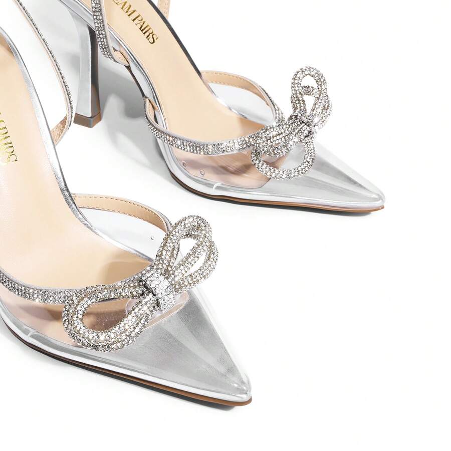 Women's rhinestone ankle strap high heels with pointed closed toe, strappy bow details, and stiletto heel for wedding and prom wear.