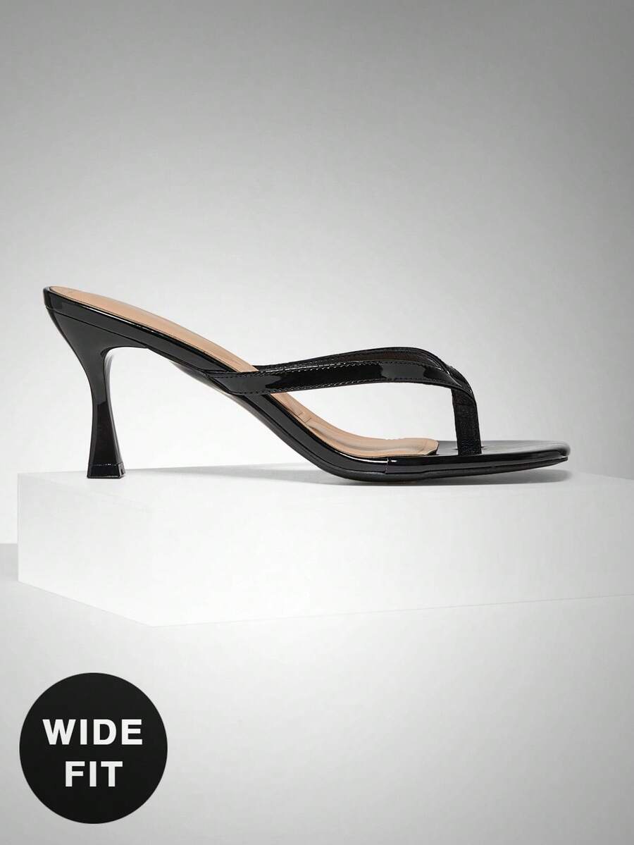 Women's square toe kitten heel thong heeled sandals featuring an asymmetrical strap design and mid heel