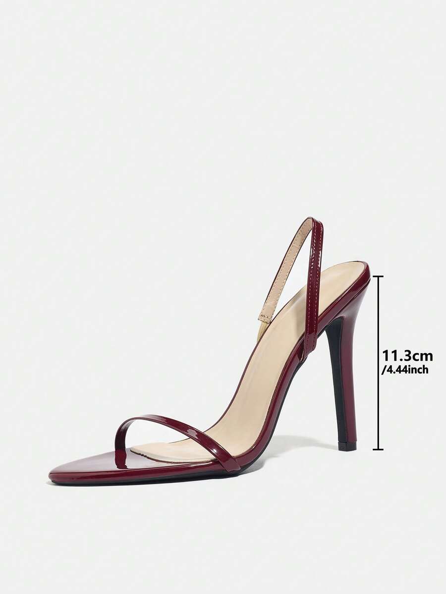 Women's stiletto high heel sandals with round open toe and back ankle strap in solid finish.
