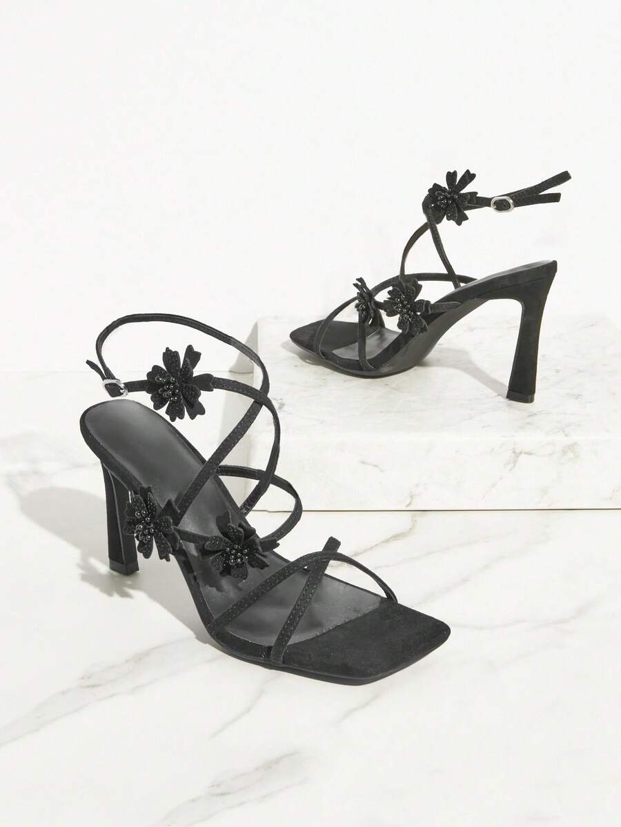 Open square toe high heel sandals with sparkling rhinestone straps, an adjustable ankle buckle closure, and a sleek stiletto heel.