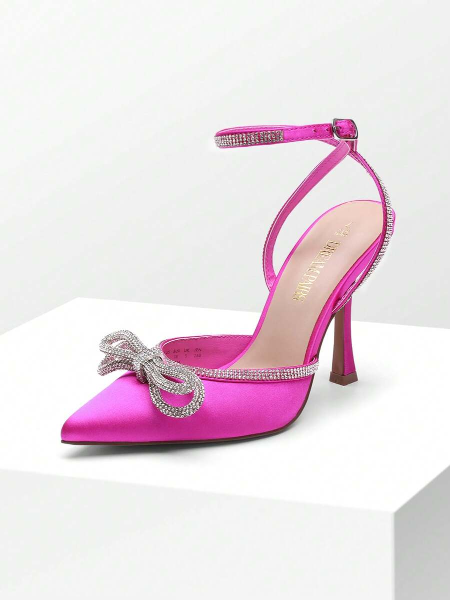 Women's rhinestone ankle strap high heels with pointed closed toe, strappy bow details, and stiletto heel for wedding and prom wear.