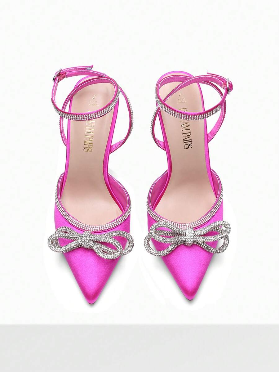 Women's rhinestone ankle strap high heels with pointed closed toe, strappy bow details, and stiletto heel for wedding and prom wear.