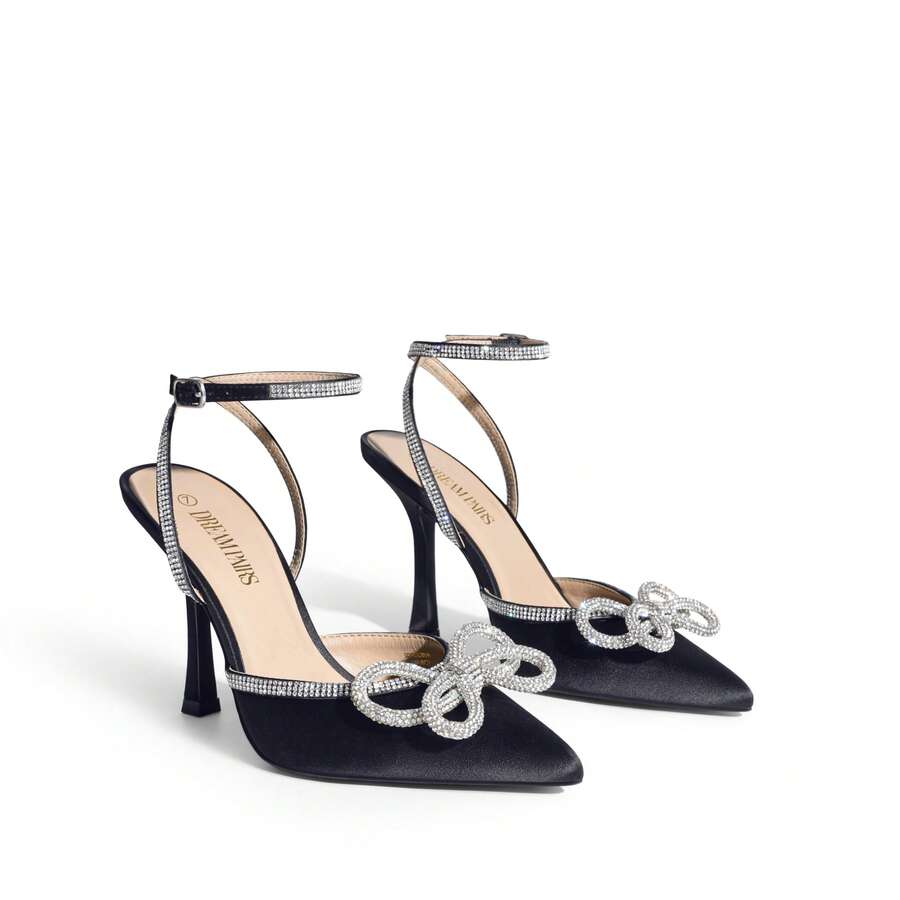 Women's rhinestone ankle strap high heels with pointed closed toe, strappy bow details, and stiletto heel for wedding and prom wear.