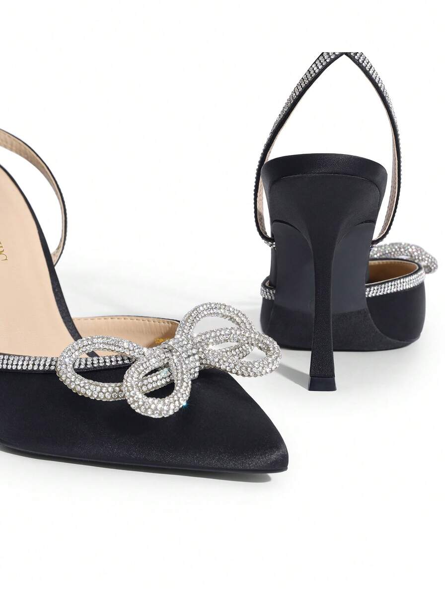Women's rhinestone ankle strap high heels with pointed closed toe, strappy bow details, and stiletto heel for wedding and prom wear.