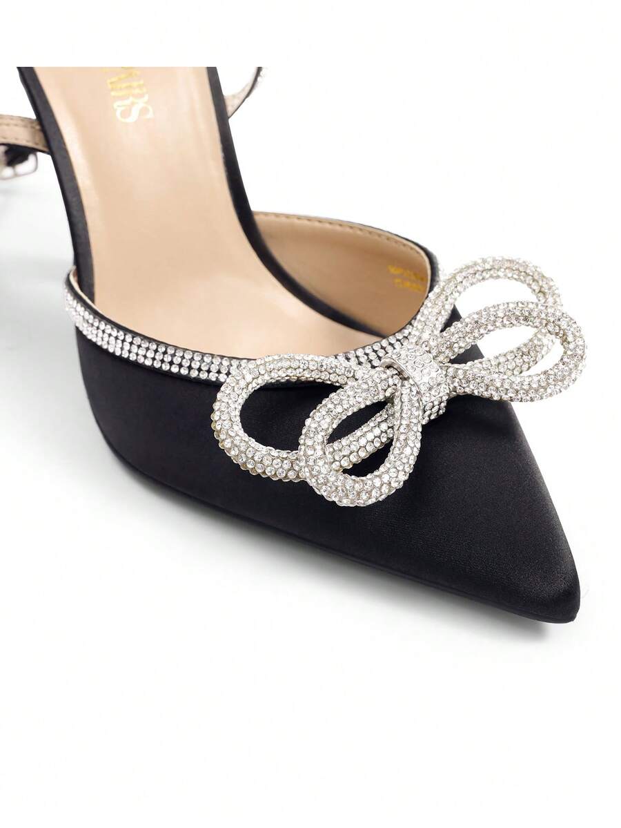 Women's rhinestone ankle strap high heels with pointed closed toe, strappy bow details, and stiletto heel for wedding and prom wear.