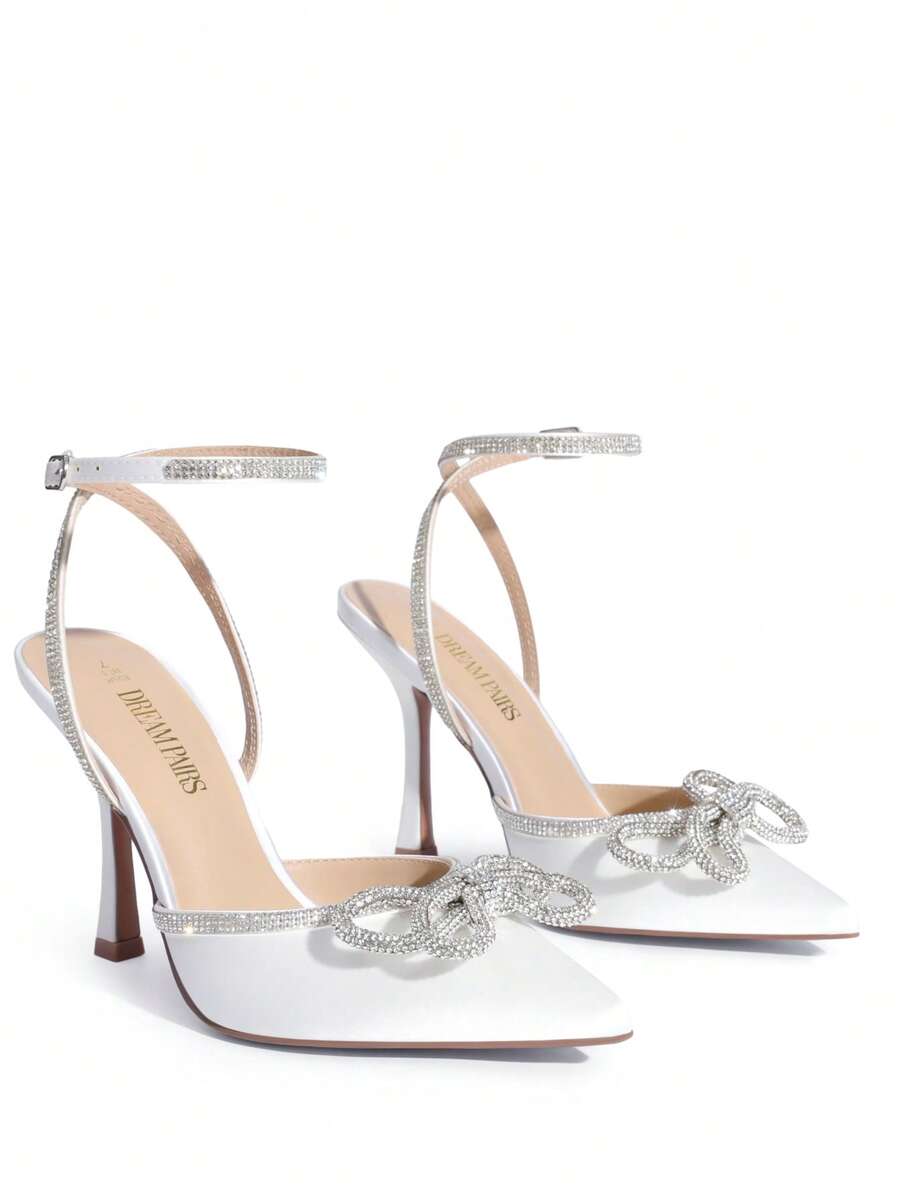 Women's rhinestone ankle strap high heels with pointed closed toe, strappy bow details, and stiletto heel for wedding and prom wear.