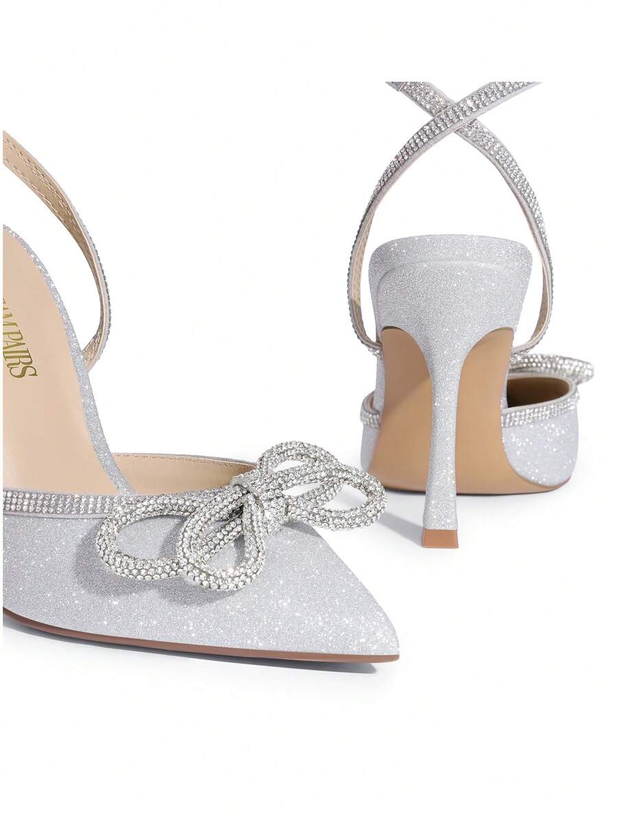 Women's rhinestone ankle strap high heels with pointed closed toe, strappy bow details, and stiletto heel for wedding and prom wear.