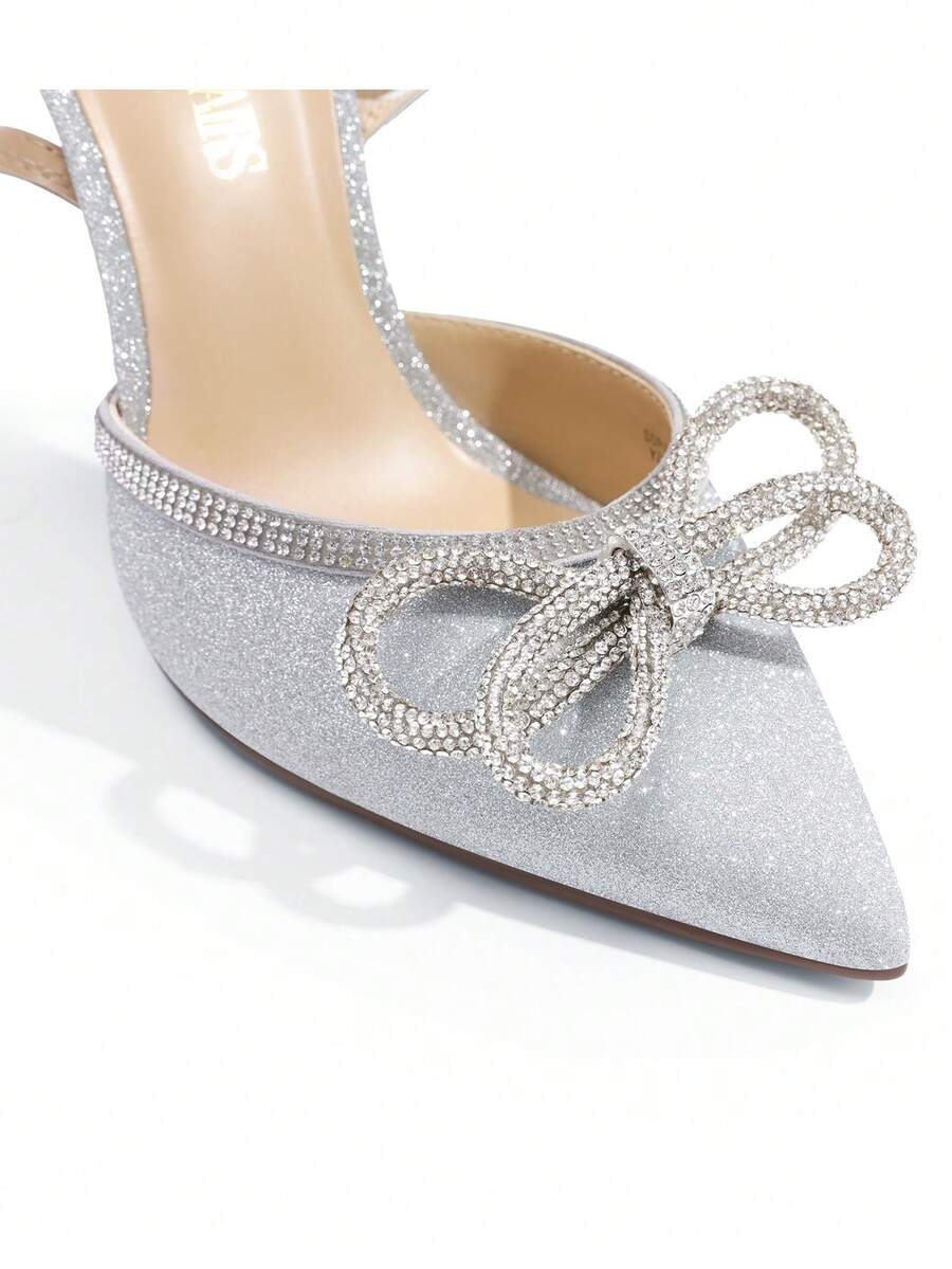 Women's rhinestone ankle strap high heels with pointed closed toe, strappy bow details, and stiletto heel for wedding and prom wear.