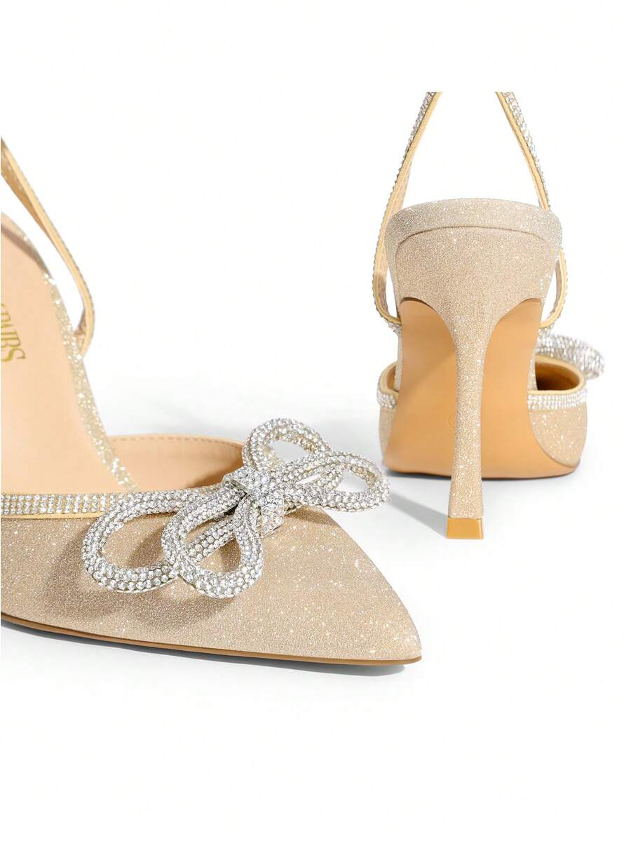 Women's rhinestone ankle strap high heels with pointed closed toe, strappy bow details, and stiletto heel for wedding and prom wear.