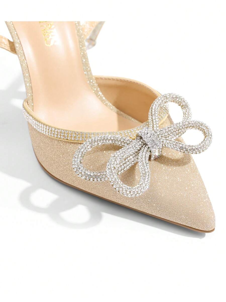 Women's rhinestone ankle strap high heels with pointed closed toe, strappy bow details, and stiletto heel for wedding and prom wear.