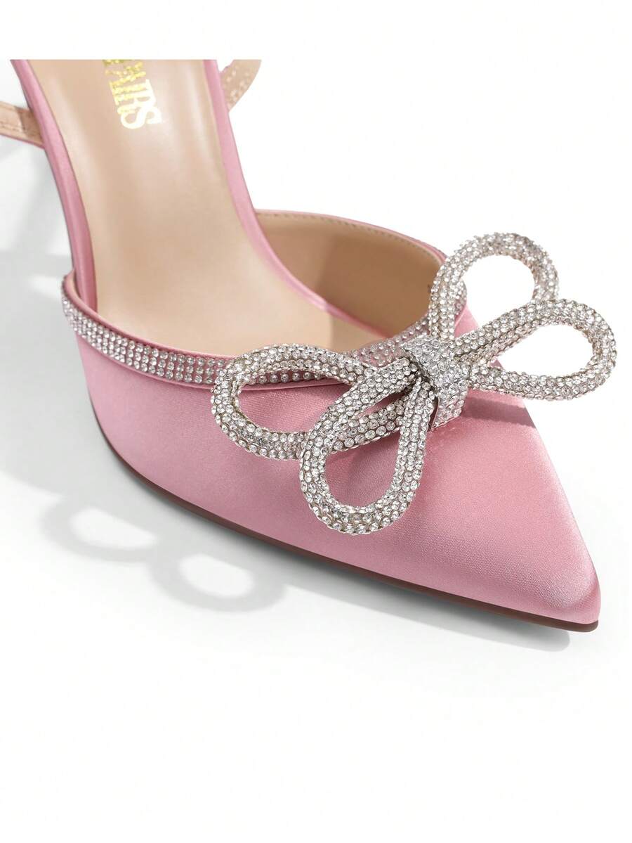 Women's rhinestone ankle strap high heels with pointed closed toe, strappy bow details, and stiletto heel for wedding and prom wear.