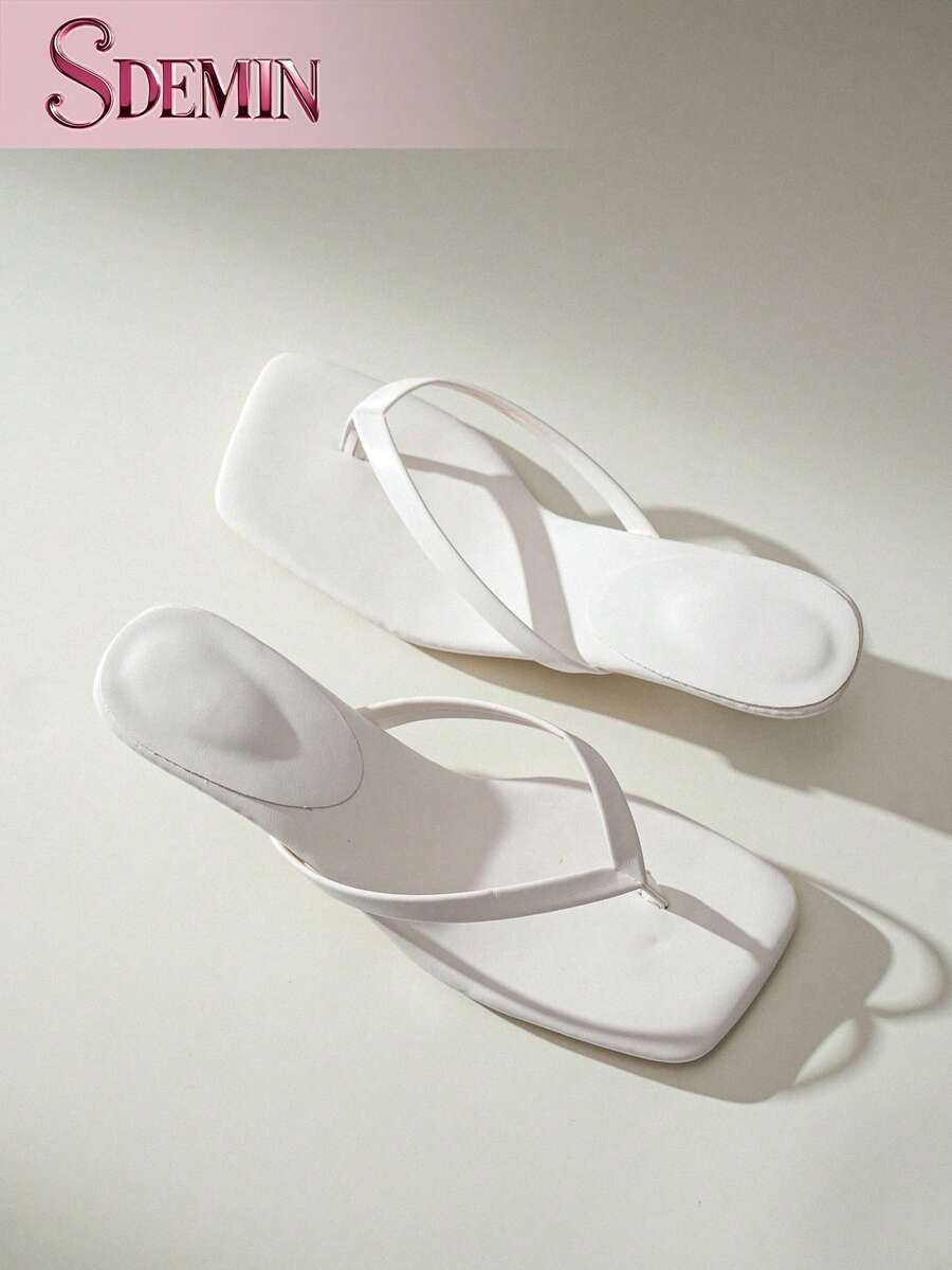 Women's slip-on kitten high heel sandals featuring a square toe and toe post thong design in solid PU leather.