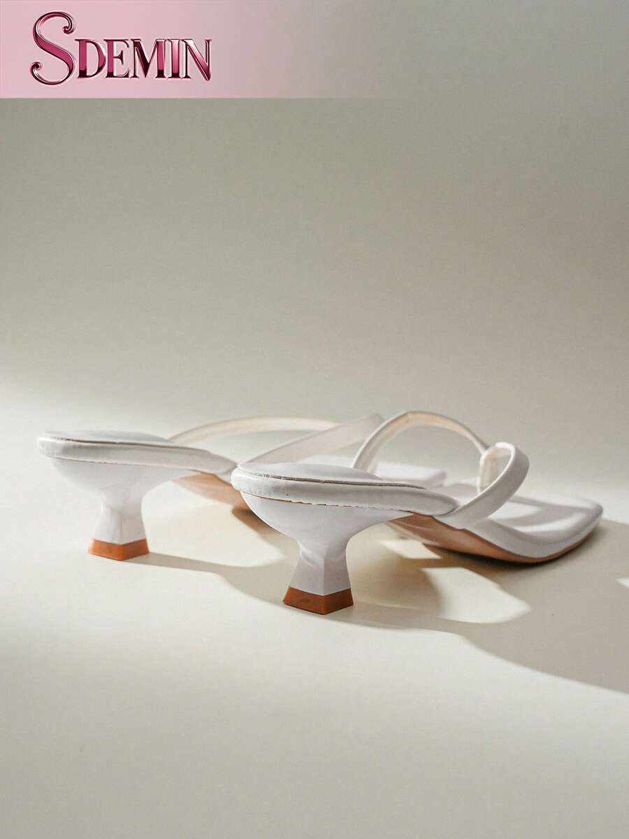 Women's slip-on kitten high heel sandals featuring a square toe and toe post thong design in solid PU leather.