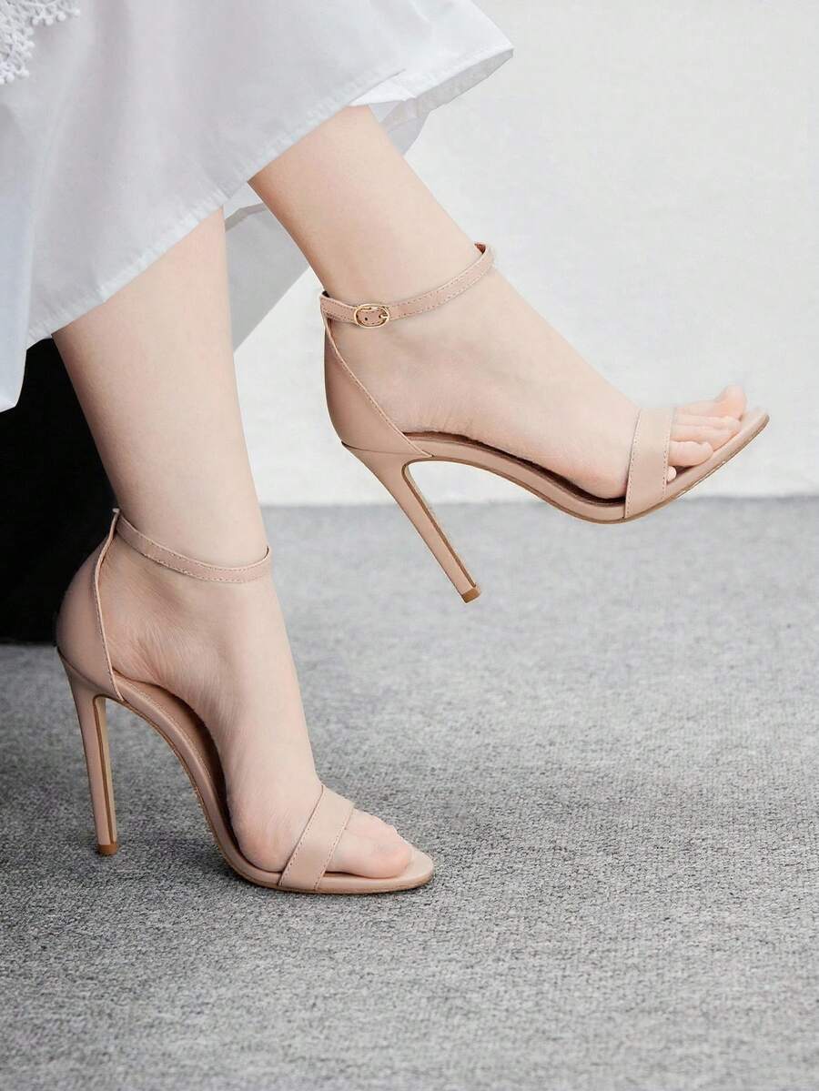 Women's stiletto sandals featuring an ankle strap buckle closure and classic round open toe design.