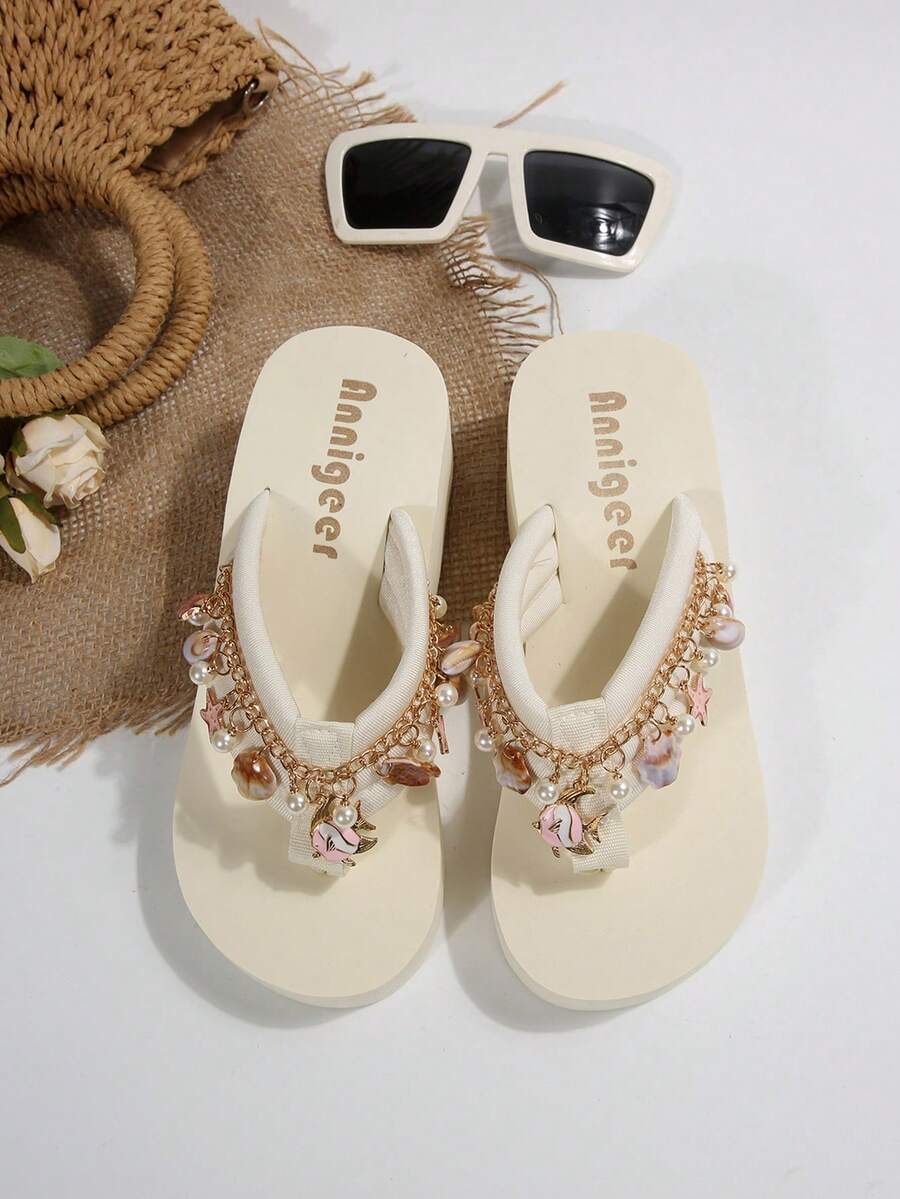 Beige platform wedge flip flop slippers featuring decorative chain and shell details with EVA sole for women.