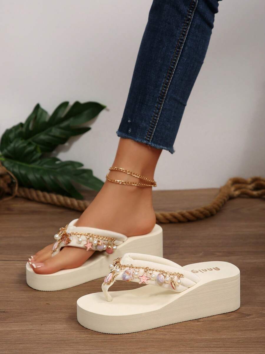 Beige platform wedge flip flop slippers featuring decorative chain and shell details with EVA sole for women.