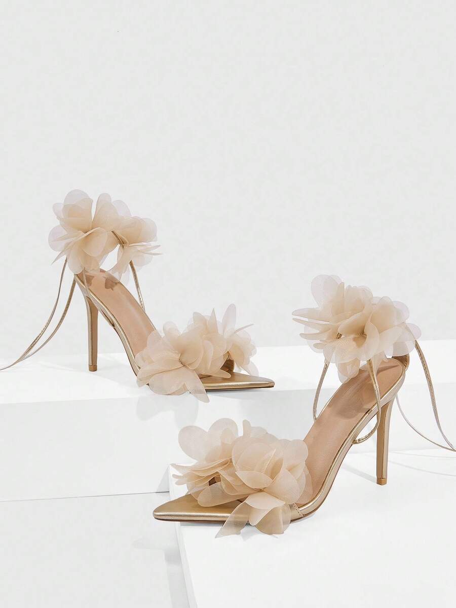 Women's open toe heeled sandals featuring 3D floral decor, satin lace-up ankle straps, and stiletto high heels.