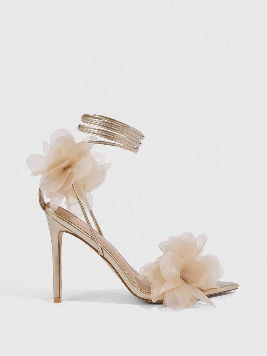 Women's open toe heeled sandals featuring 3D floral decor, satin lace-up ankle straps, and stiletto high heels.
