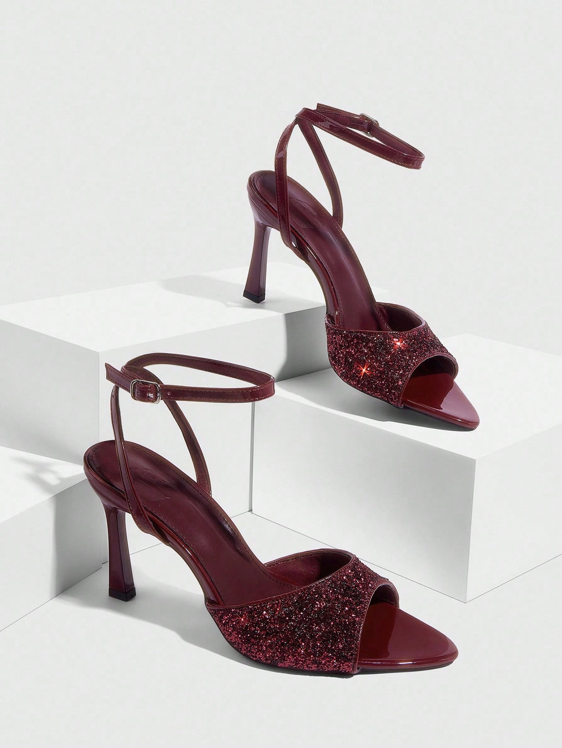 Sequin decorated high heel sandals featuring an open toe design, stiletto heel, and adjustable ankle strap buckle.