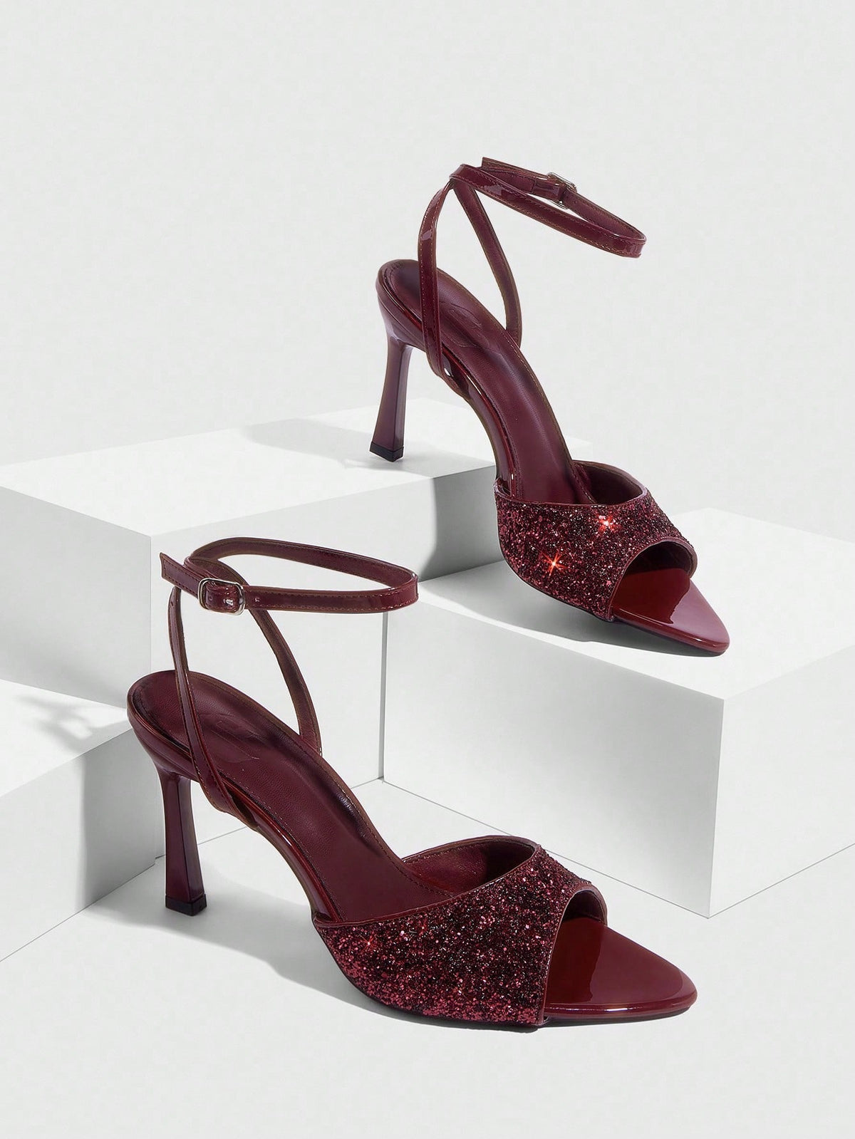 Sequin decorated high heel sandals featuring an open toe design, stiletto heel, and adjustable ankle strap buckle.