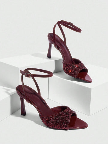 Sequin decorated high heel sandals featuring an open toe design, stiletto heel, and adjustable ankle strap buckle.