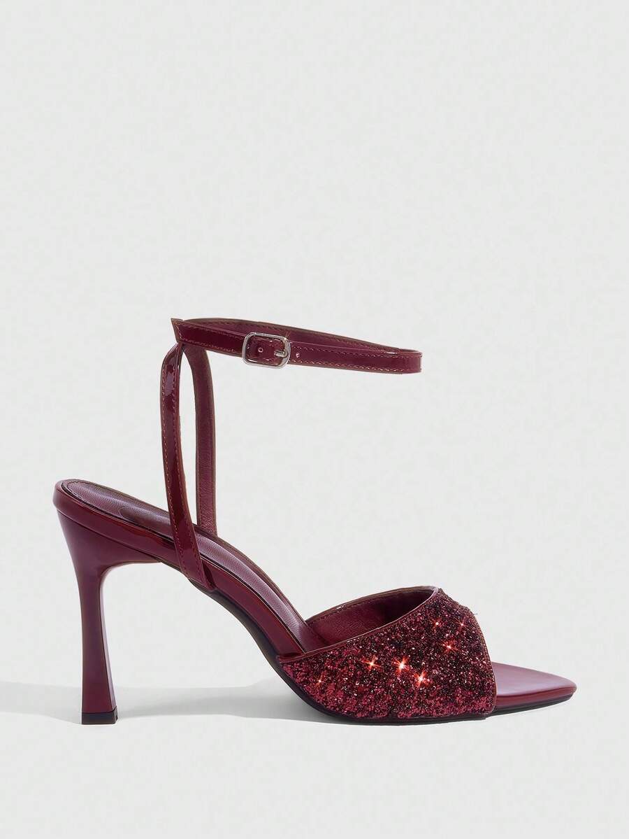 Sequin decorated high heel sandals featuring an open toe design, stiletto heel, and adjustable ankle strap buckle.