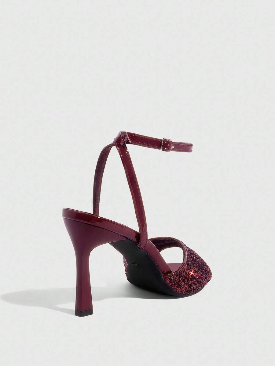Sequin decorated high heel sandals featuring an open toe design, stiletto heel, and adjustable ankle strap buckle.