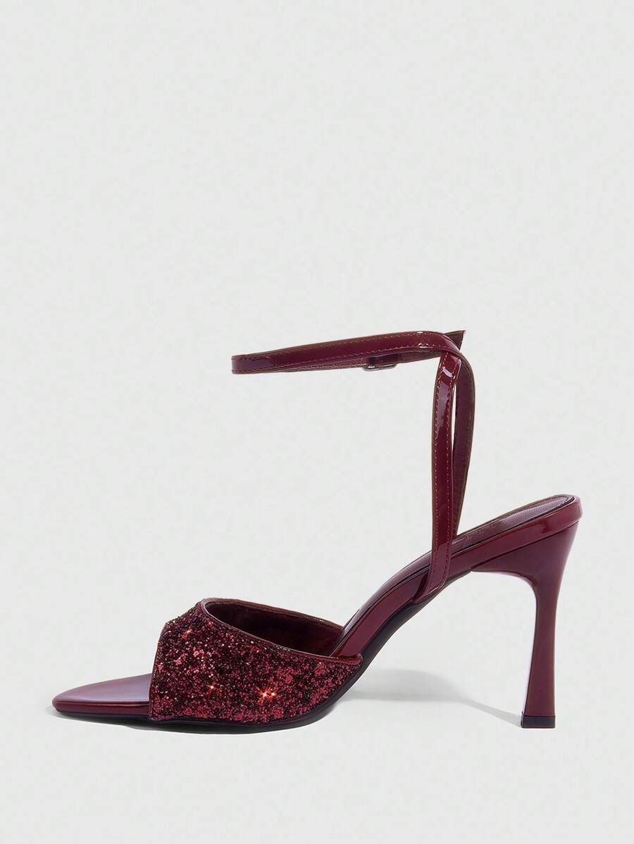 Sequin decorated high heel sandals featuring an open toe design, stiletto heel, and adjustable ankle strap buckle.
